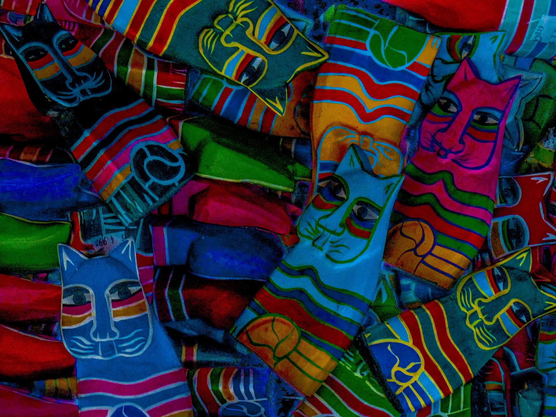 Colorful toys scattered in a pile in bright colors, all cat shapes