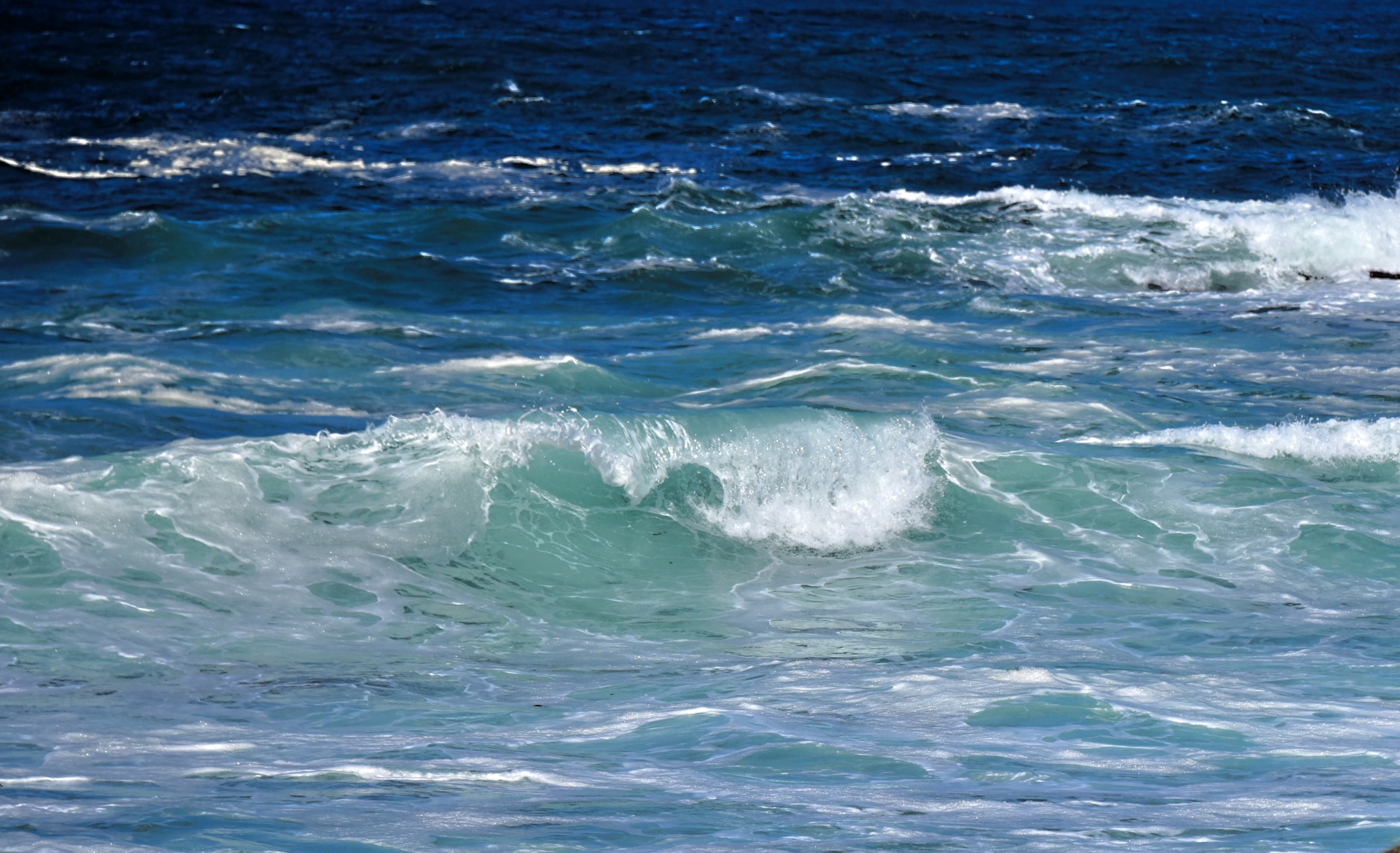 Wave curls of blue ocean background