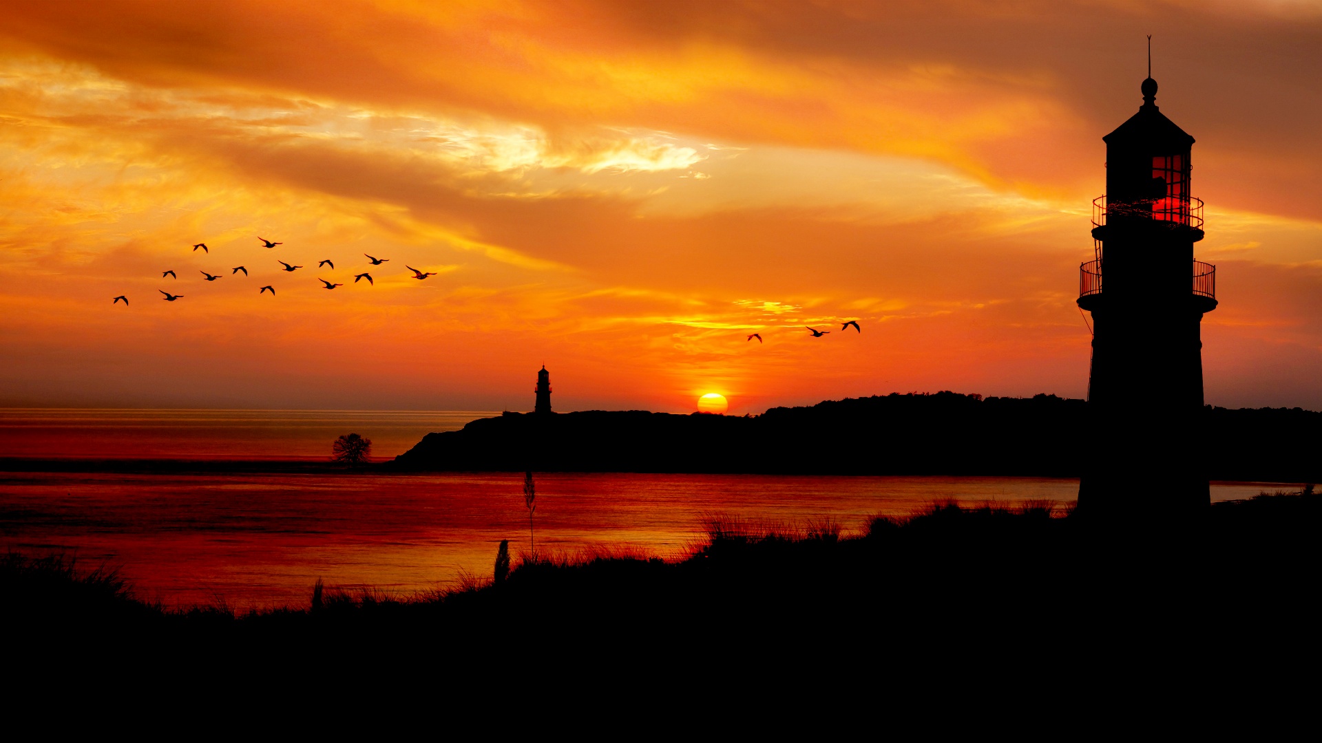 Sunset over the ocean with lighthouse, birds and grass