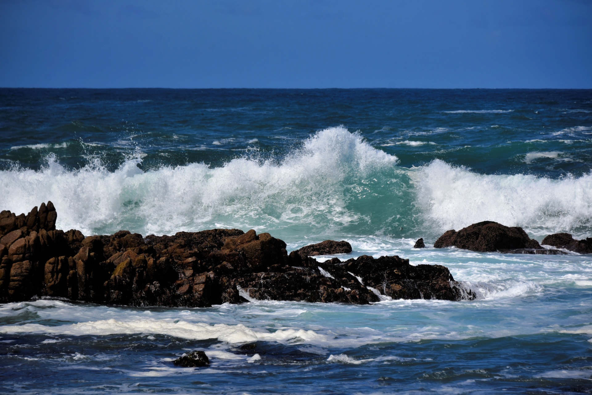 Waves Crashing On Rocks Of The Sea
