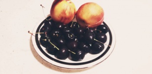 A Plate Of Cherries And Peaches