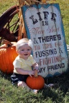 Baby Beside Sign With Pumpkins