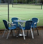 Table And Chairs Next To Tennis