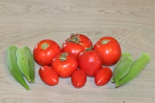 Tomatoes And Okra On Wooden Table