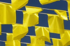 Yellow Flags Against Blue Sky