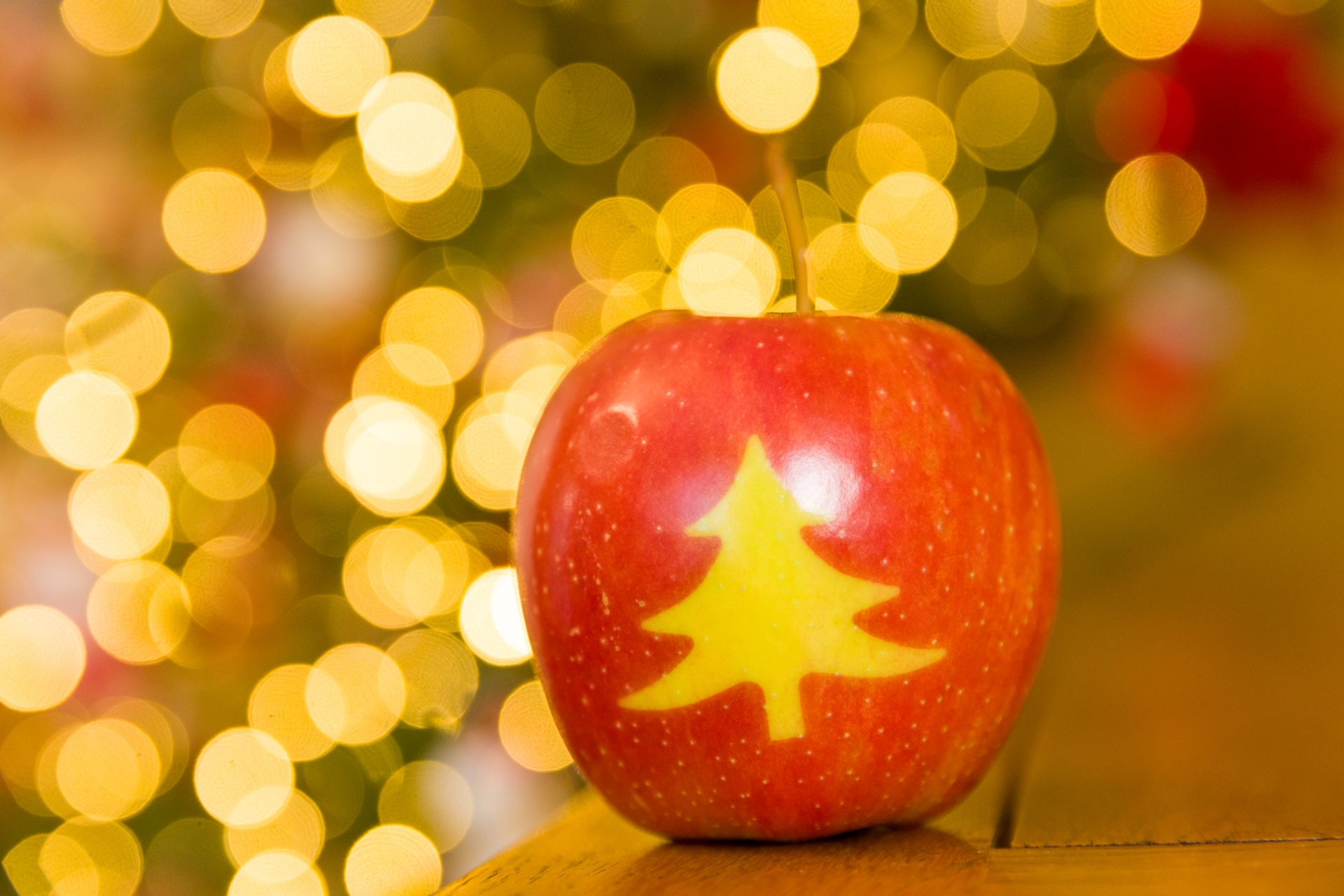 Christmas apple with bokeh lights in the background