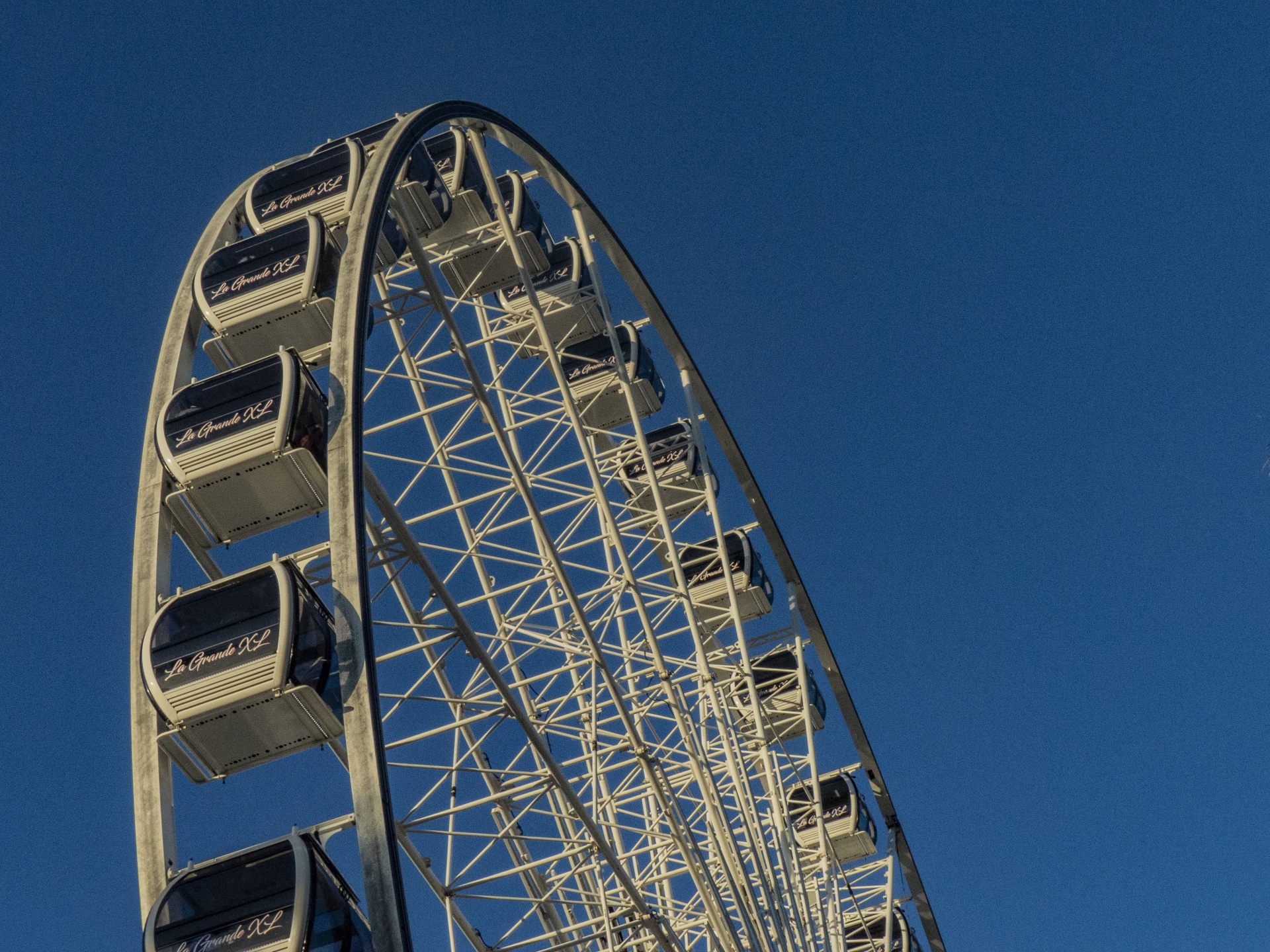 Enclosed car Ferris wheel against a clear blue sky