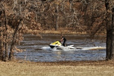 Boy Riding Jet Ski In Pond
