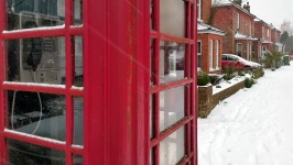 English Phone Box On A Snowy Street