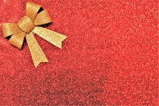 Gold Bow On Red Glitter Background