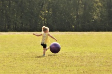 Little Girl Kicking Big Ball