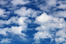 Puffy Clouds On Blue Sky Background