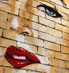 Woman's Face Painted On Brick Wall