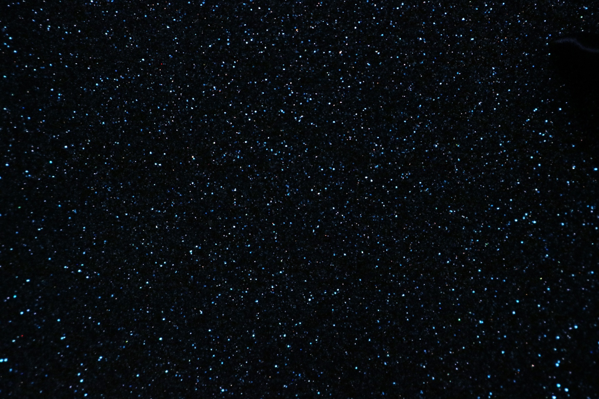 Dark blue glitter sparkling abstract background.
