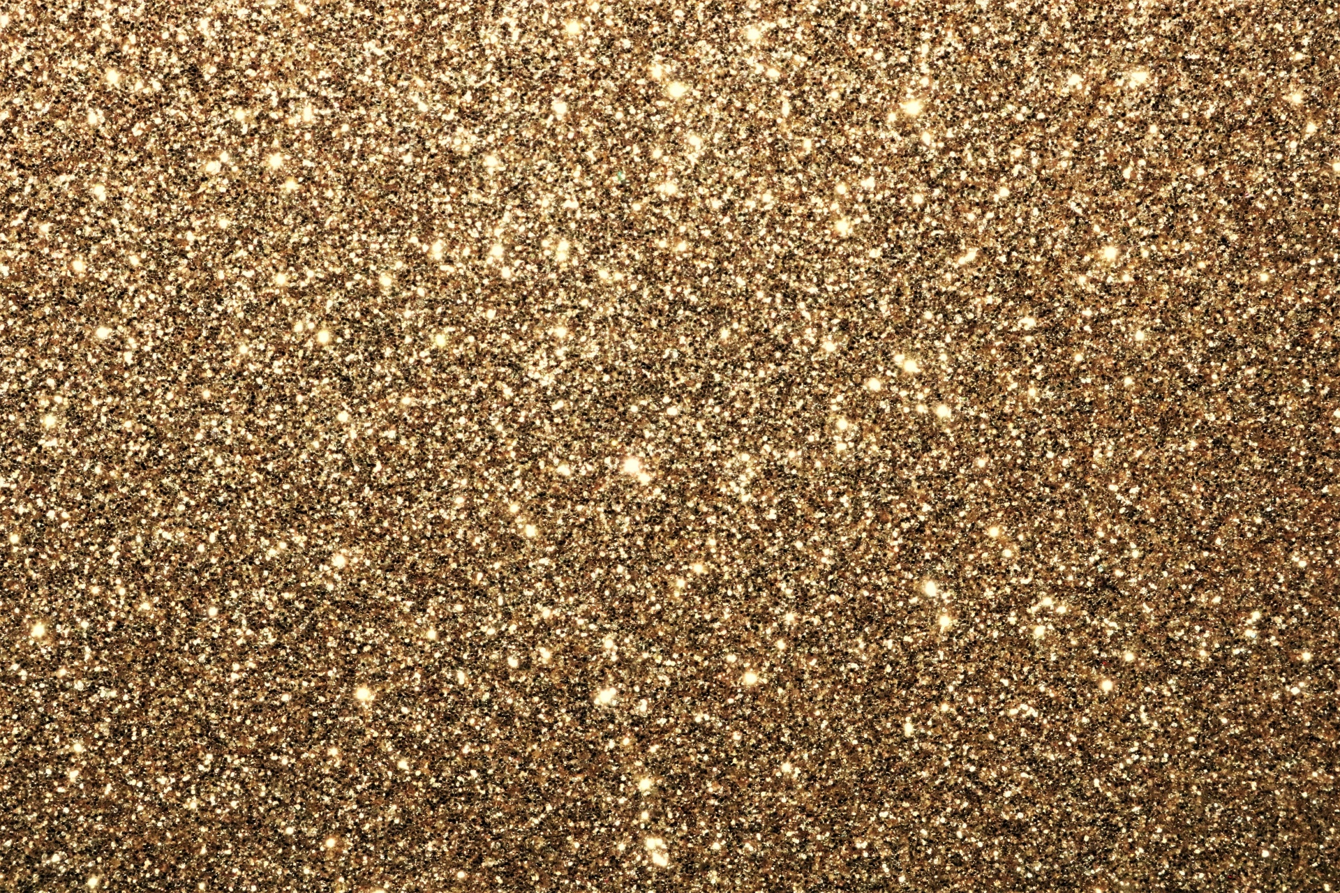 A sparkling gold glitter background with room for text.