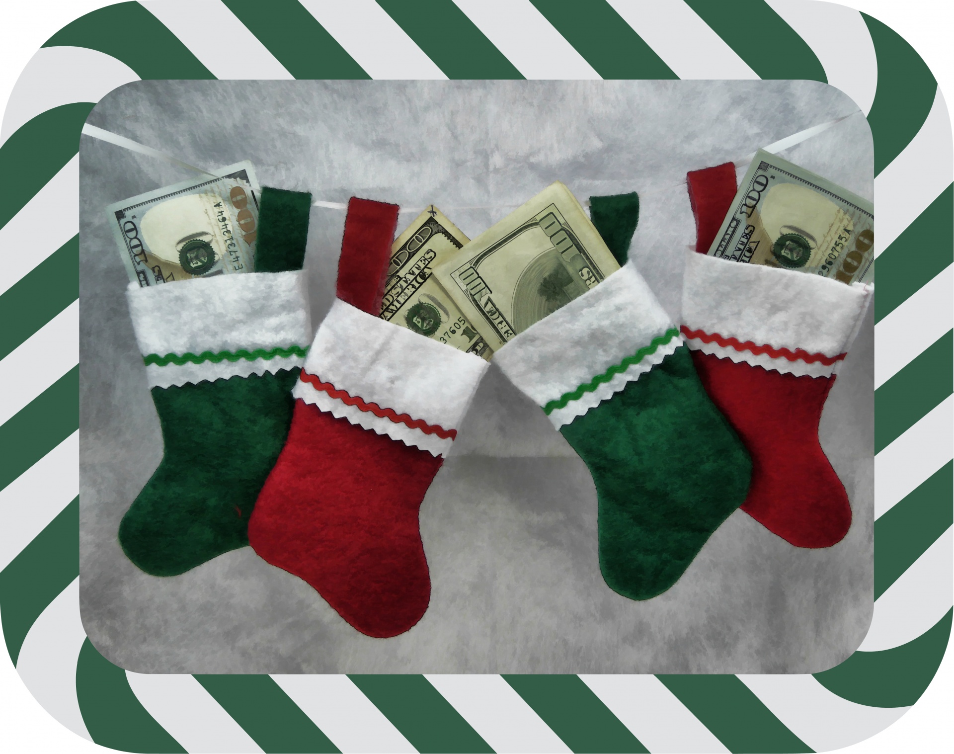 Small Christmas socks with a one hundred dollar bills in each one