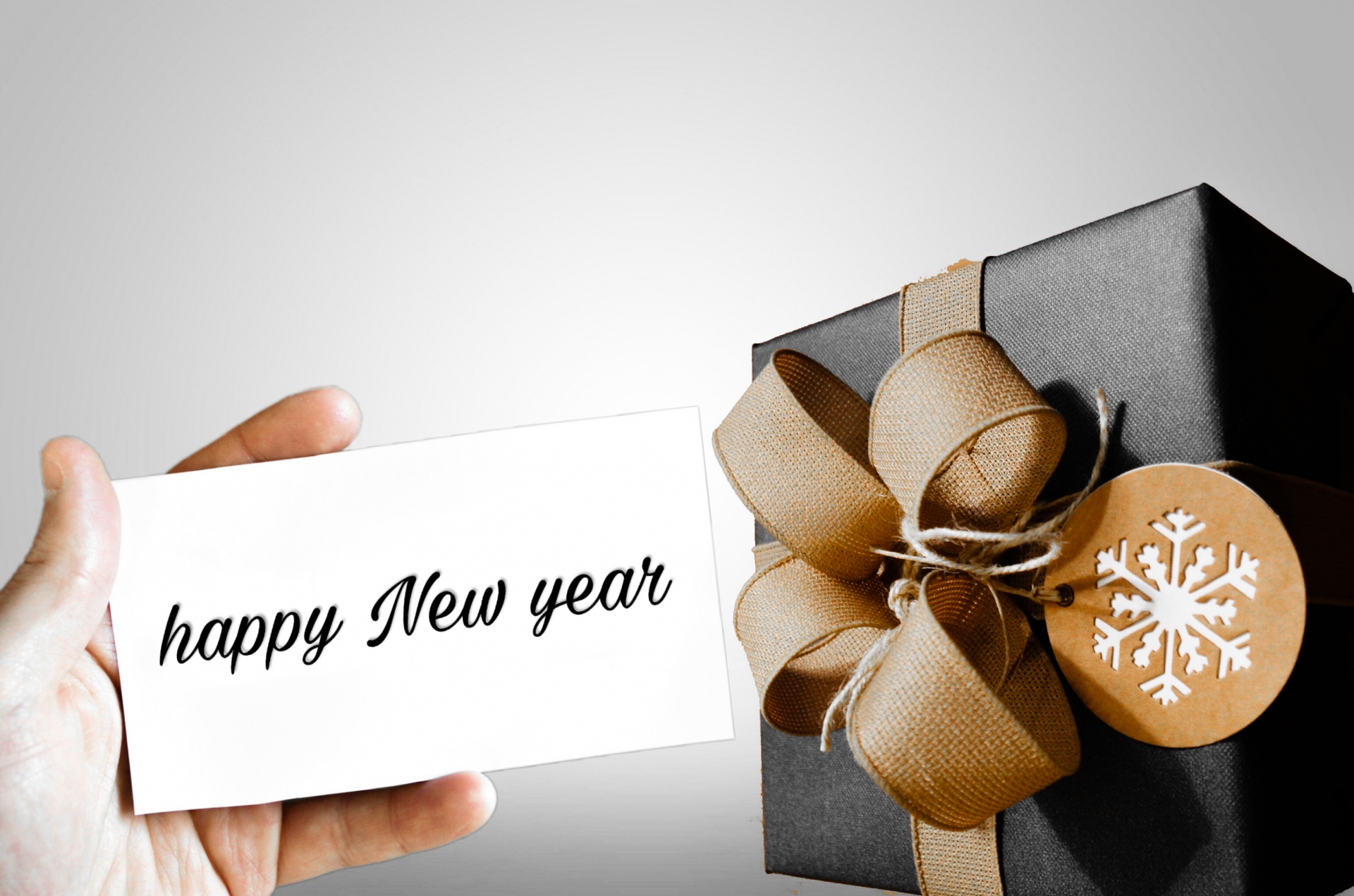 new year, present, gift, happy new year, hand, greeting, card, celebration, paper, 2019, 2020, message, communication, font, simple, box, bow, ribbon, black, package, christmas