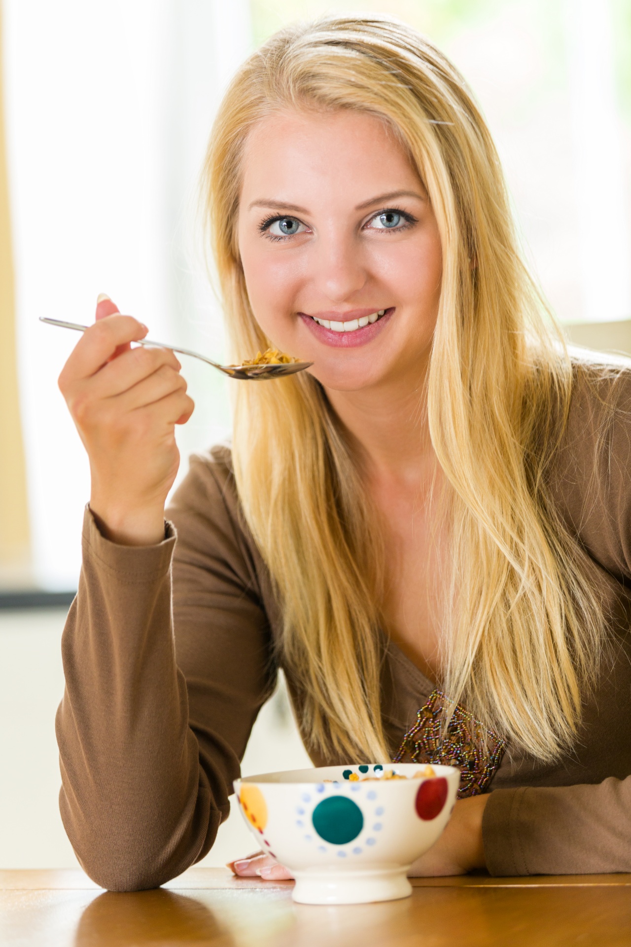 Young woman eating cereals for breakfast
