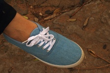 Blue Canvas Shoe On A Lady's Foot