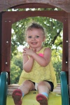 Happy Little Girl On Slide