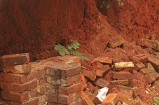 Mound Of Caved In Earth With Bricks