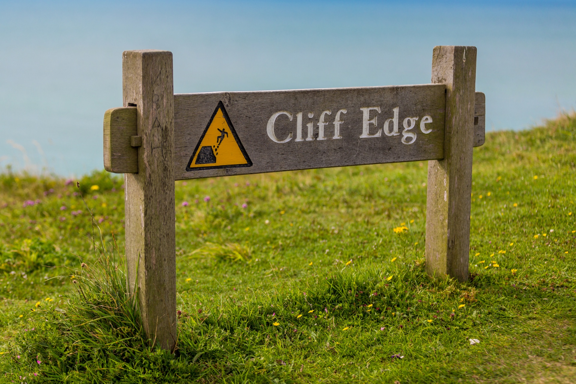 Wooden cliff edge sign