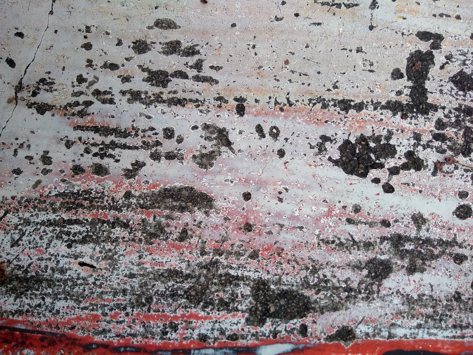 Faded and Aged Grey Concrete Texture with Hints of Red Paint Color