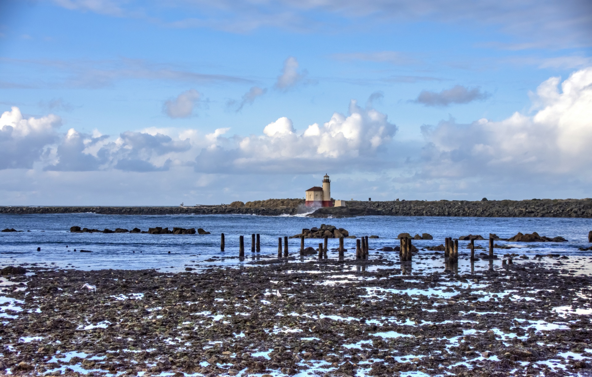 Looking across bay at low tide to a lighthouse