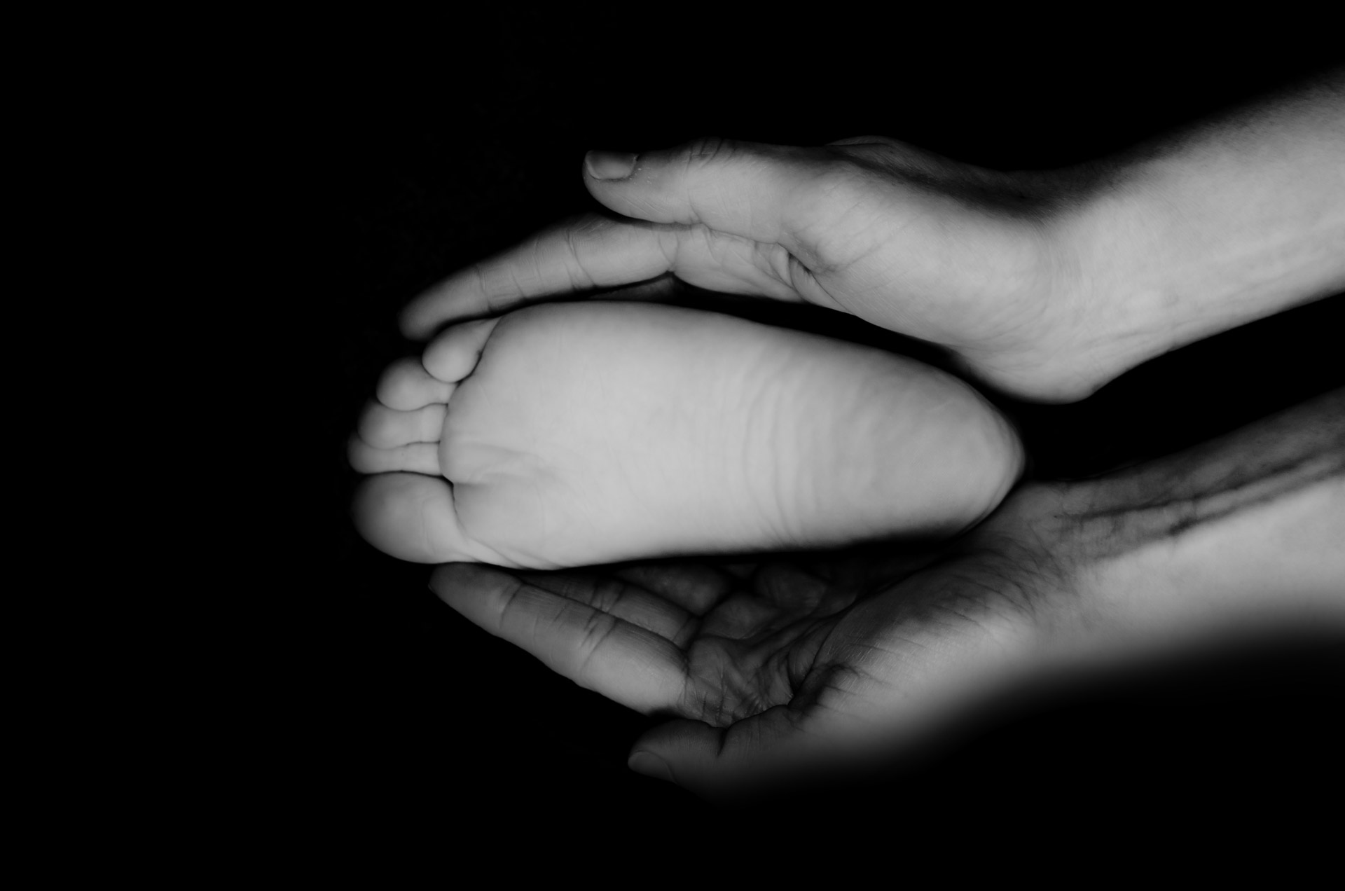 Child's Foot In The Palms