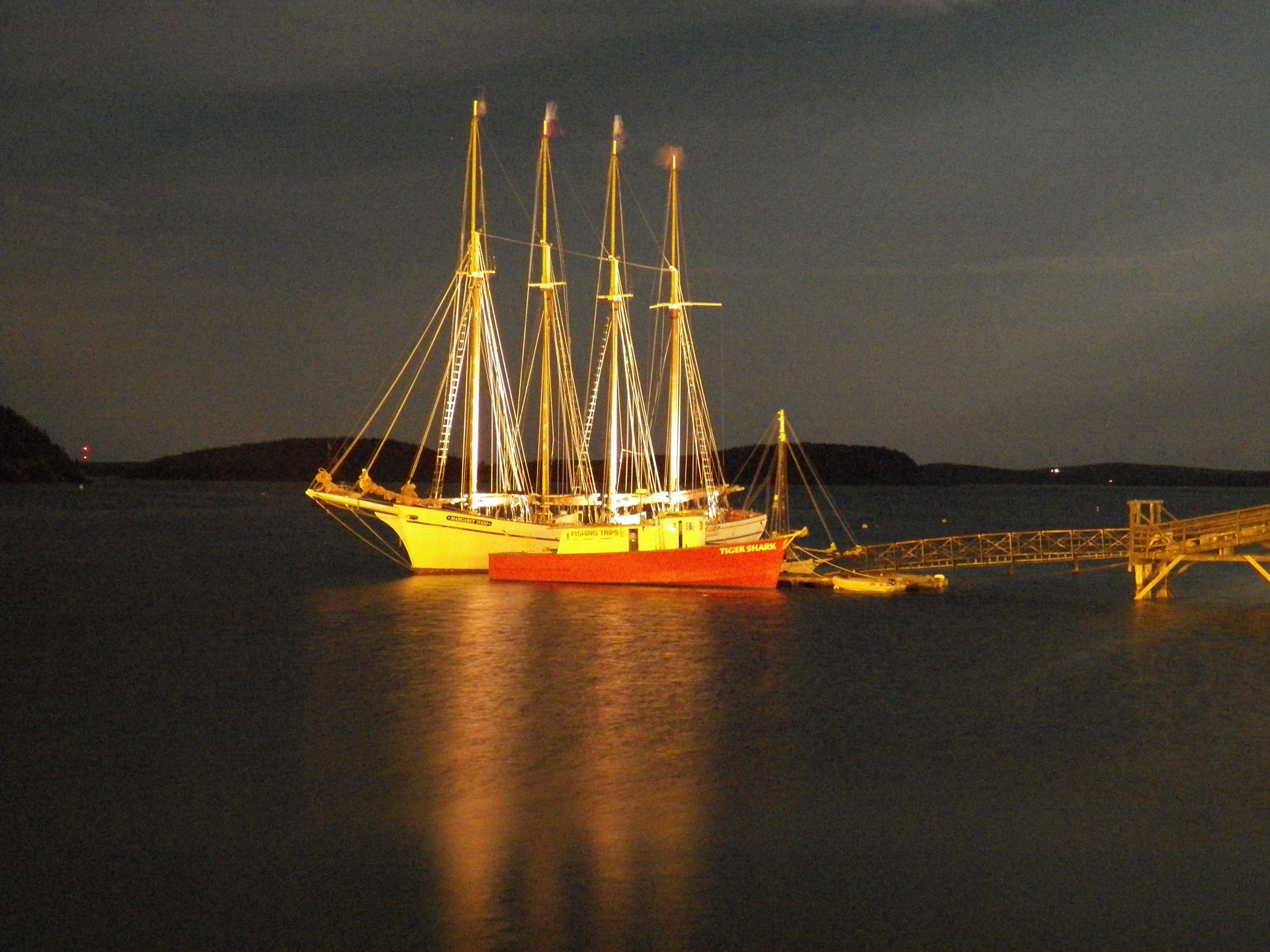 photo of a four masted schooner in moonlight