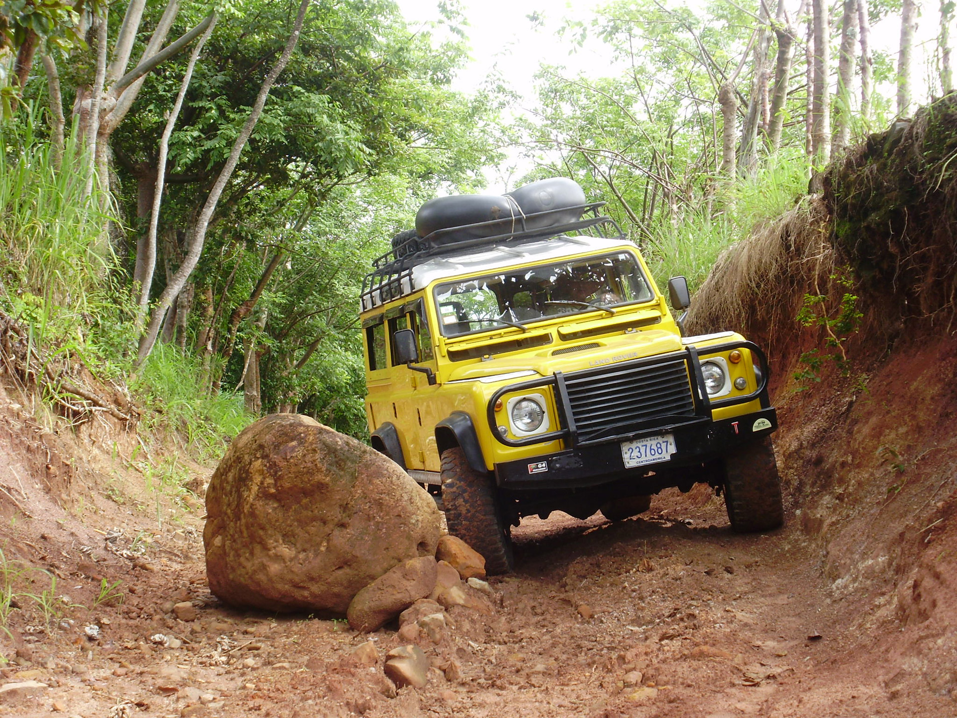 Land Rover on the way to the river pauses for a fallen rock