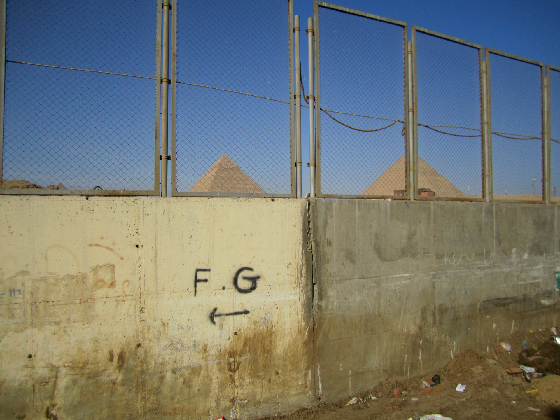 The pyramids through a fence