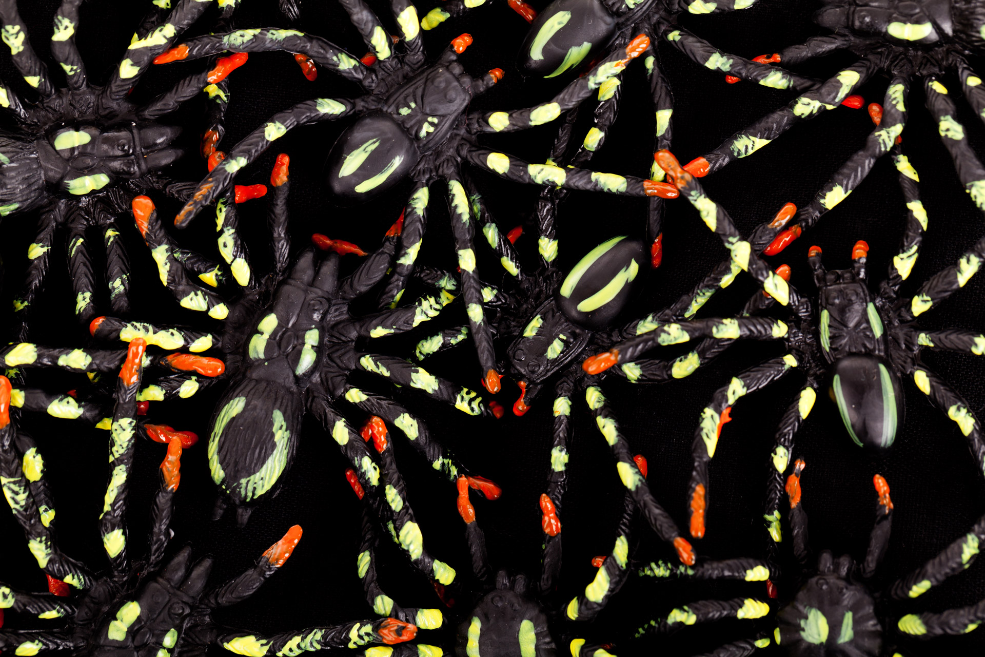 colorful spiders on dark Halloween background