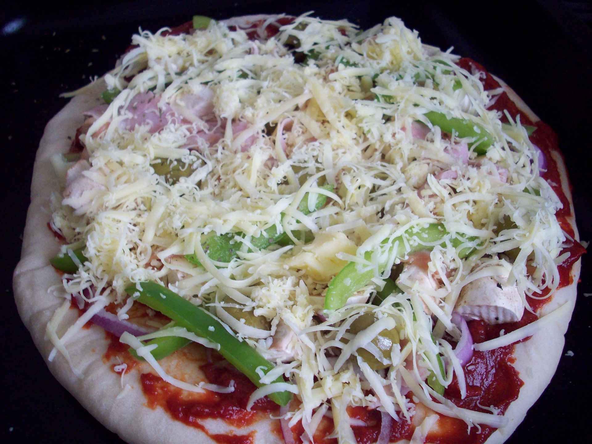 photo of uncooked pizza ready for the oven