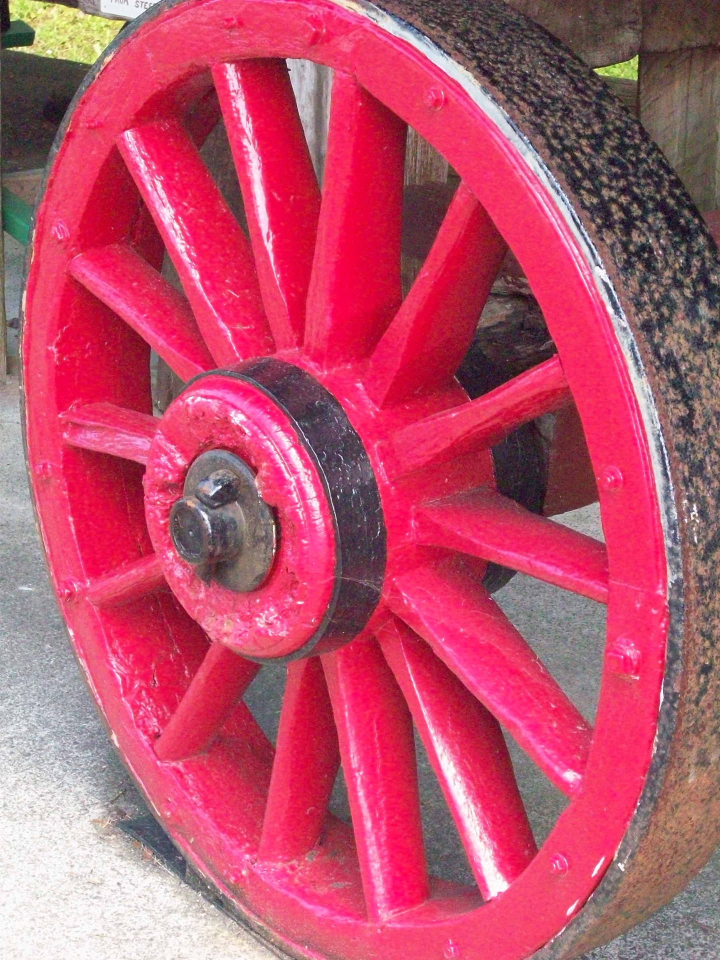 Close up of old red wooden wheel.