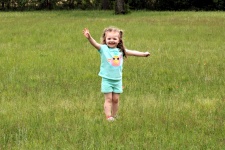 Happy Little Girl In Grass