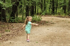 Little Girl Walking In Woods