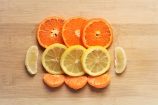 Oranges And Lemons On Cutting Board