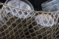 Wooden Barrels In Fishing Net