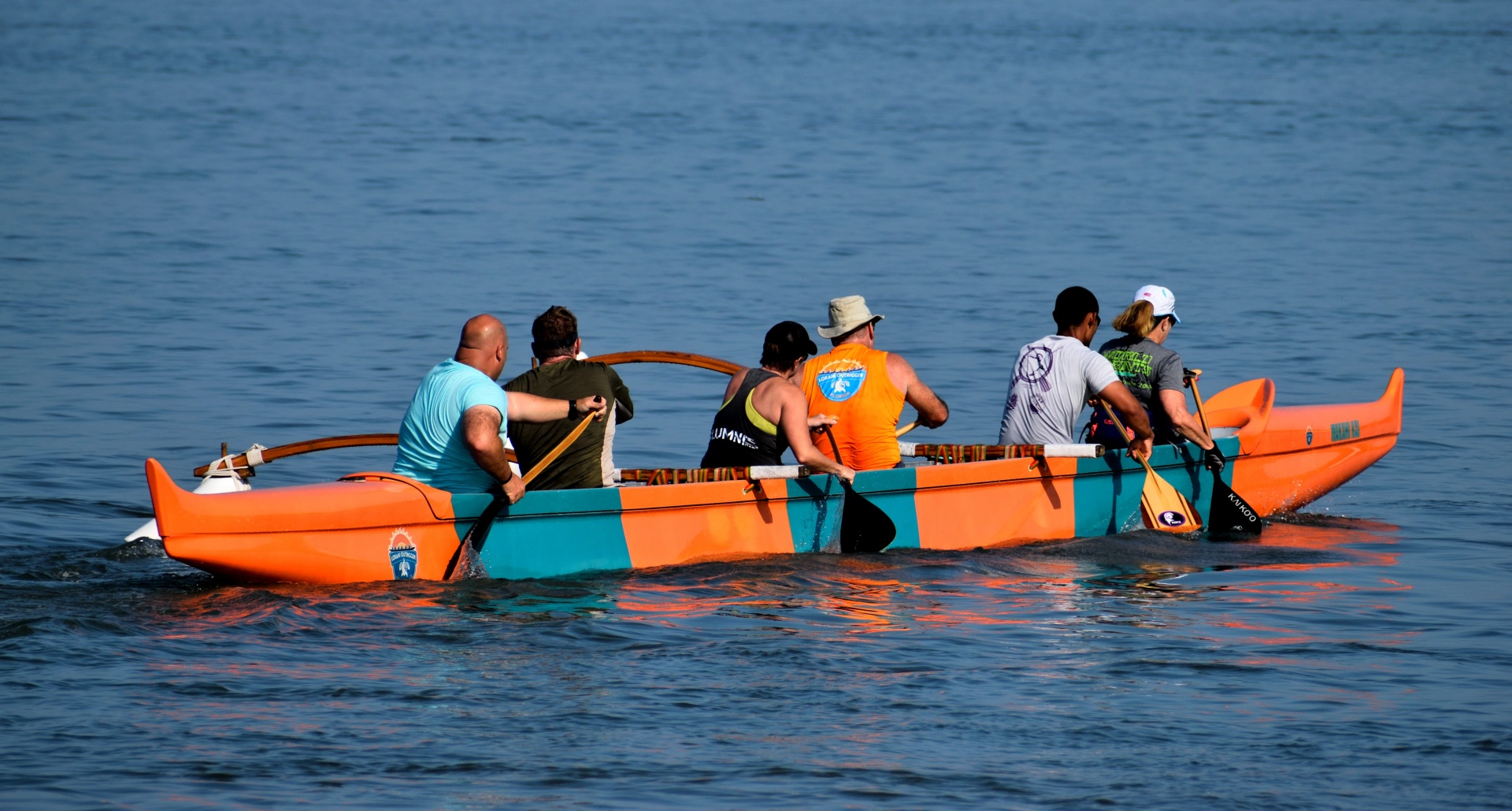 Group of people rowing on Hawaiian Outrigger Canoe