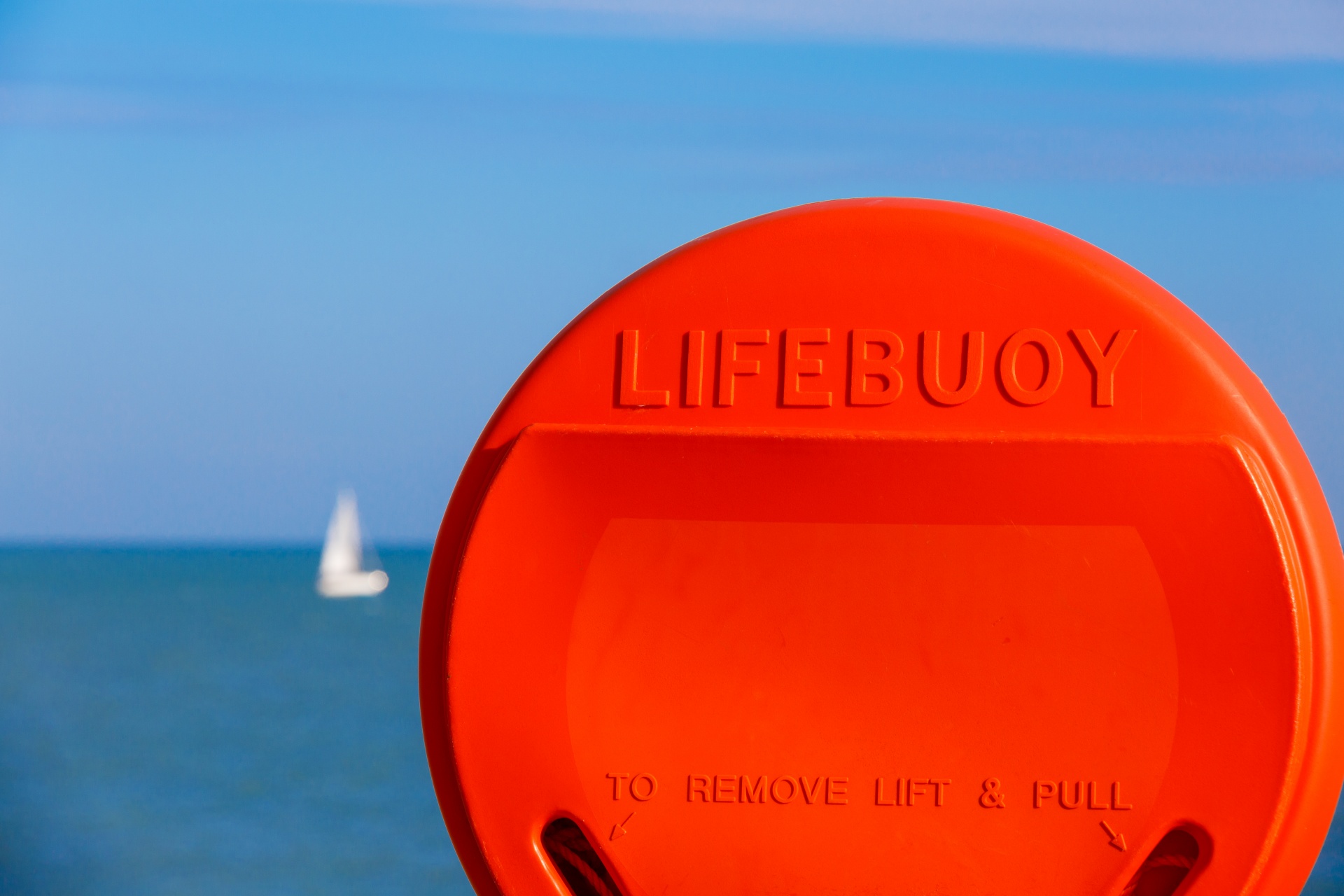 Orange lifebuoy on a shore