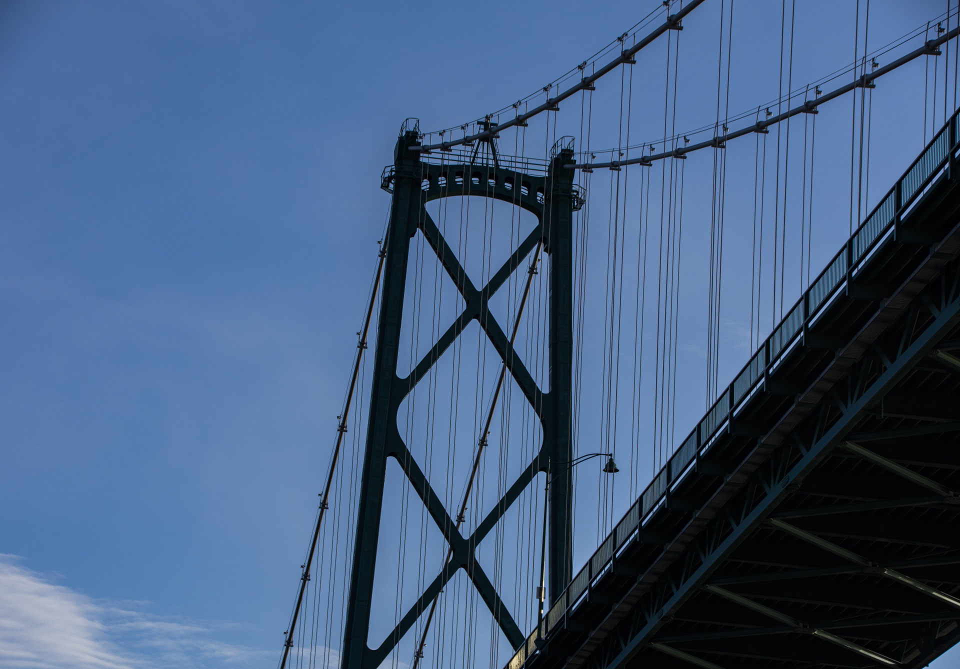 looking up at silhouette of Vancouver's Lions Gate Bridge