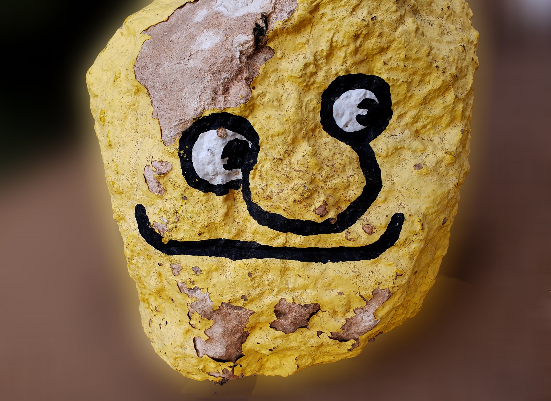 funny face smiling painted on a rock