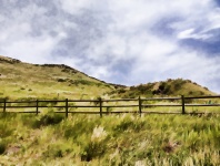 Fence Around Grassy Hills