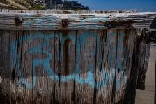 Blue Graffiti On Wood Fence