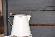 Milk Pitcher And Wood Background