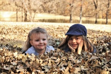 Two Little Girls Lying In Leaves