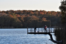 Two Men Fishing On Pier In Fall
