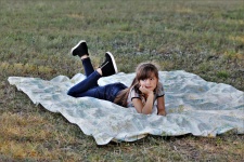 Young Girl On Blanket In Grass
