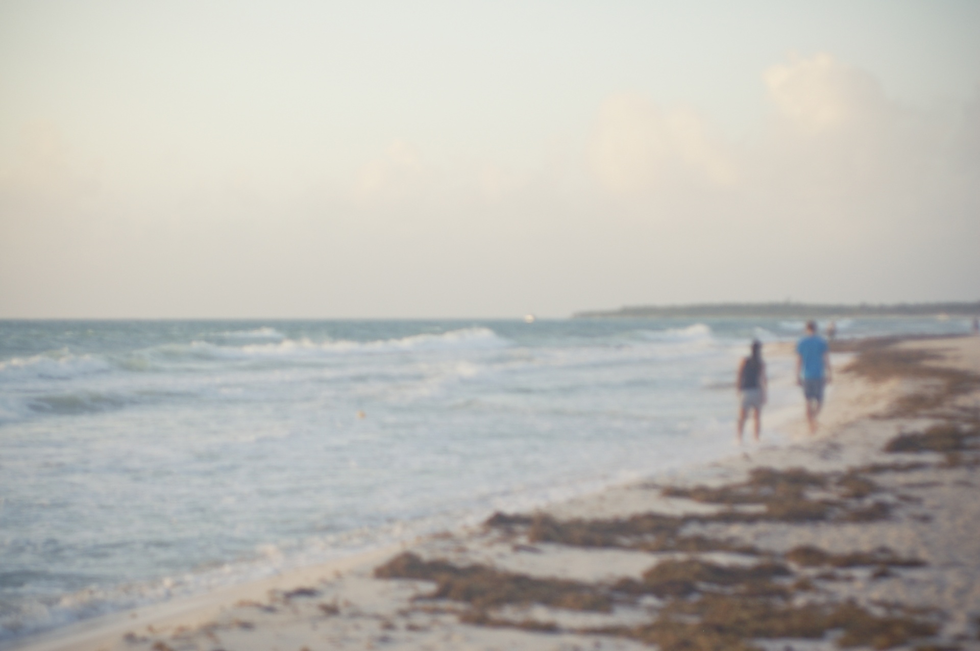 Blurred Couple Walking On The Beach
